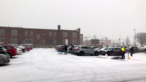 Busy-Costco-retail-parking-lot-with-people-stocking-up-on-supplies-during-winter-snowfall