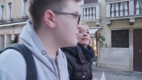 Mother-and-Son-Sightseeing-on-a-busy-street-in-Venice-Italy-for-Yearly-Vacation
