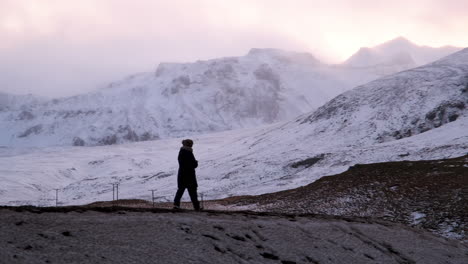 Woman-hikes-in-iceland-in-the-winter-near-Kirkjufell-Mountain
