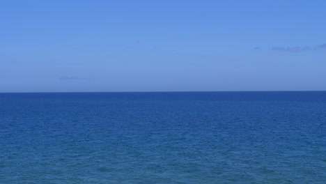 Beautiful-calm-blue-sea-and-cloudless-sky.-Static