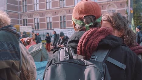 Male-and-female-young-protesters-hugging-at-Extinction-Rebellion-Climate-change-protest-in-Amsterdam