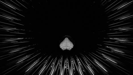 VJ-Loop---3D-Heart-Rolling-Along-a-Glowing,-Circular-Black-and-White-Tunnel