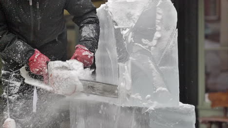 Close-up-of-chainsaw-cutting-through-ice-sculpture