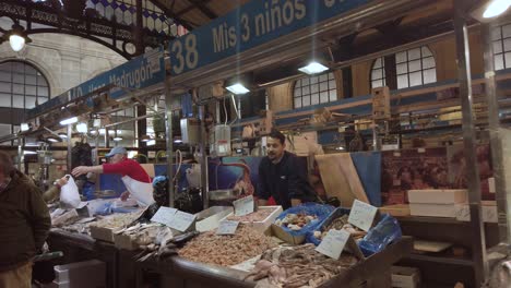 Walking-past-market-stands-with-fresh-fish-and-seafood,-Slow-Motion