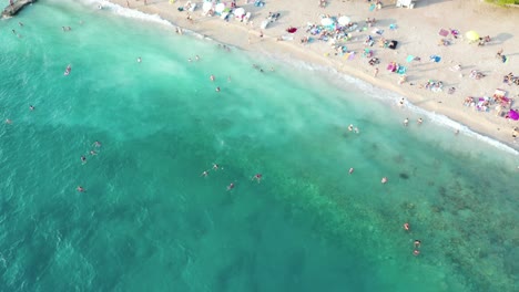 Aerial-top-down-view-of-people-swimming-in-sea