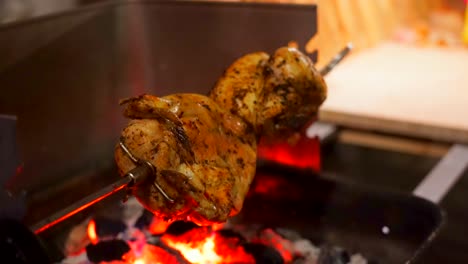 Whole-roasted-Chicken-meat-Grilled-On-Fire-during-barbecue-event