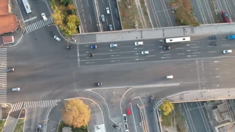 Car-moving-on-a-big-busy-crossroad,-drone-topdown-timelapse