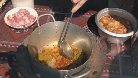 Slow-Motion-Shot-of-the-Ingredients-for-a-Curry-Being-Stirred-in-a-Pot-at-a-Khmer-Cooking-Class-in-Cambodia