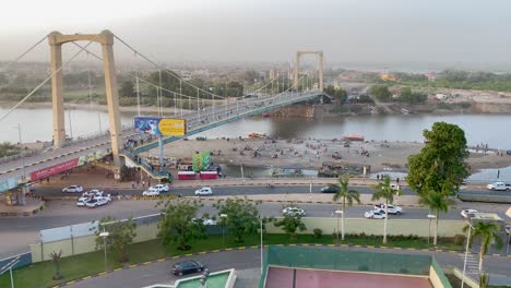 Time-lapse-looking-from-a-tall-building-over-a-bridge-to-an-island-in-the-Nile-River-where-the-Blue-and-White-Nile-Rivers-converge-in-Khartoum,-Sudan