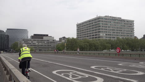 An-ambulance-with-blues-lights-flashing-rushes-towards-an-emergency-over-an-almost-deserted-Westminster-Bridge-and-past-St-Thomas’s-hospital-during-the-Coronavirus-outbreak