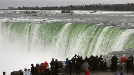 Tourists-looking-at-a-famous-Niagara-falls-in-winter