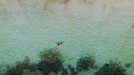 Aerial-shot-of-girl-swimming-at-Sairee-Beach-Koh-Tao,-Thailand