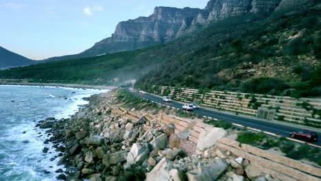rough-and-rocky-coastline-near-Camps-Bay-with-cars-driving-on-the-coastal-highway