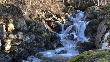 Frozen-Schlattbach-flowing-river-cascade-in-winter-season-at-Switzerland,-medium-shot