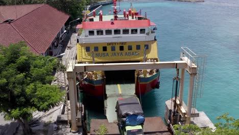 Cargo-truck-exiting-the-vehicle-ferry-at-Port-Roro-coming-from-Padang-Bai-in-Bali,-Aerial-pedestal-up-shot