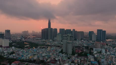 Colorful-aerial-urban-sunrise-with-high-rise-building-hidden-in-low-cloud