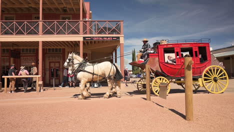 Tourists-Being-Driven-Around-In-The-Traditional-Horse-drawn-Stagecoach-In-Allen-Street-Tombstone,-Arizona-Under-The-Sunny-Day