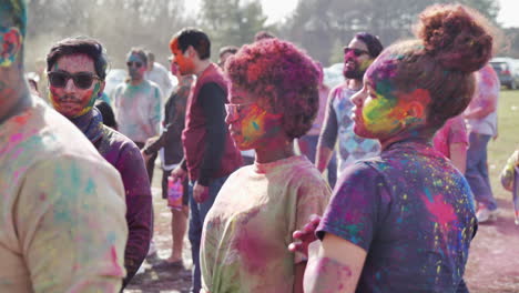 Two-women-in-colored-powder-dancing-at-Holi-Festival