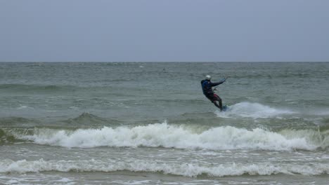 Singe-man-jumps-while-kite-surfing-during-winter-on-Baltic-sea