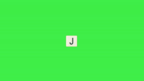Buchstabe-J-Scrabble-Rutsche-Von-Links-Nach-Rechts-Auf-Grünem-Bildschirm,-Buchstabe-J-Grüner-Hintergrund