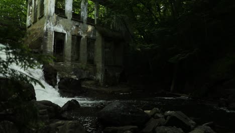Old-abandoned-mill-in-the-middle-of-a-gorgeous-river-ravine-surrounded-by-woods-in-the-middle-of-the-Gatineau-hills,-Quebec