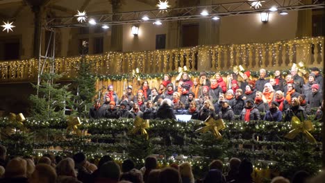 Huge-christmas-choir-singing-and-smiling-at-German-christmas-market-in-Stuttgart-Germany