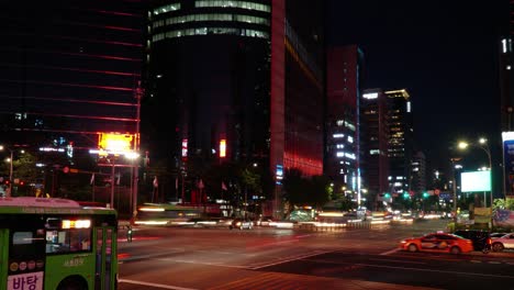 Gangnam-station-crossroad-timelapse,-light-trails-and-night-traffic-of-main-Seoul-street,-zoom-out-motion