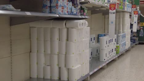 Slow-motion-interior-empty-UK-supermarket-toilet-roll-aisle-panic-buying-corona-virus