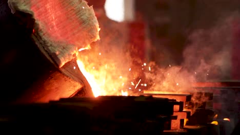Molten-metal-being-poured-from-hopper-to-cast-at-a-foundry