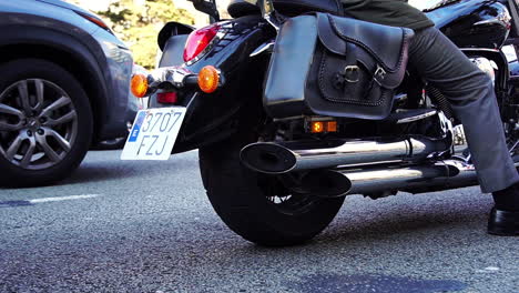 Still-shot-displaying-the-escape-pipe-of-a-motorcycle-standing-in-traffic