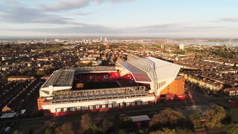 Iconic-Liverpool-Anfield-football-stadium-ground-at-sunrise-aerial-orbit-left-view