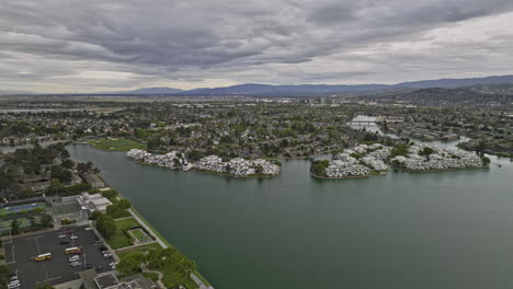 Foster-City-California-Aerial-v4-birds-eye-view-flyover-residential-neighborhood-around-central-lake-capturing-waterfront-apartments-complex-an-overcast-cloudy-day---Shot-with-Mavic-3-Cine---June-2022