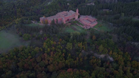 Beautiful-red-brick-medieval-Monte-Oliveto-Maggiore-abbey-on-forest-hill