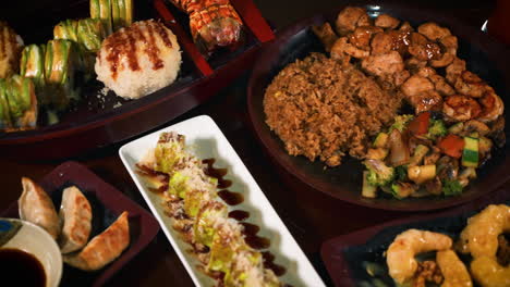 Japanese-hibachi-restaurant-tabletop-filled-with-variety-of-menu-options-from-noodles-to-sushi-to-hibachi-to-tempura-to-gyoza,-slider-4K