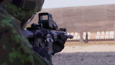 Soldier-firing-assault-rifle-in-shooting-range,-closeup,-slow-motion