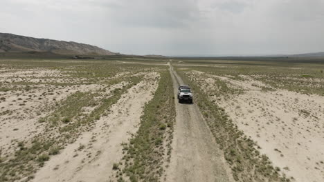 Jeep-driving-on-dirt-road-in-arid-Vashlovani-steppe-plain-in-Georgia