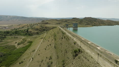 Dali-Mta-Reservoir-dam-with-desolate-control-tower-in-water,-Georgia