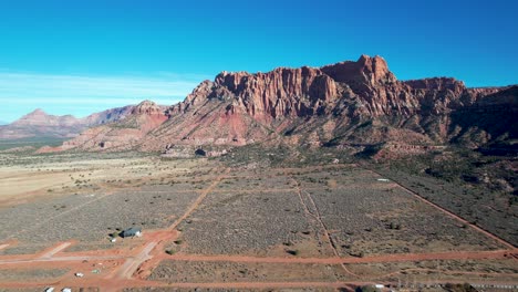 Colorado-City-Utah-small-town-with-red-rock-cliffs-and-dirt-roads---aerial