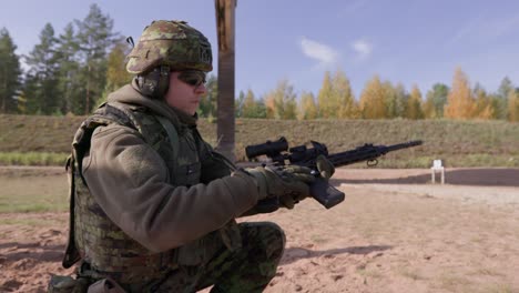 Soldier-loading-rifle-with-magazine-in-shooting-range,-midshot,-handheld