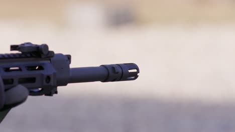 Assault-rifle-barrel-in-close-up-firing-bullets-in-slow-motion