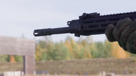 Assault-rifle-barrel-in-close-up-firing-in-shooting-range,-slow-motion