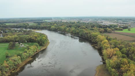 Aerial-shot-moving-down-a-wide-river-on-an-overcast-day