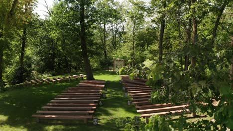 Aerial,-empty-outdoor-forest-wedding-ceremony-venue-during-the-day-with-no-one