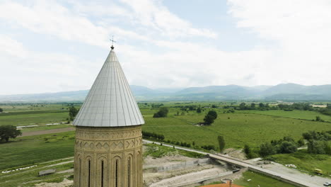 Orthodox-Alaverdi-cathedral-spire-with-cross-above-Georgia-countryside