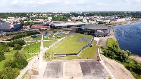 Kaunas-Nemunas-river-island-with-new-modern-pool-and-Zalgiris-arena,-aerial
