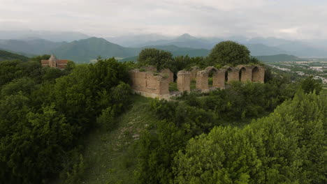 Historical-medieval-palace-ruins-on-wooded-hill-in-Alvani,-Georgia