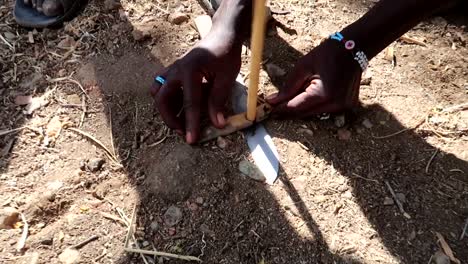 Hadzabe-tribe-teaching-how-to-make-fire-with-wooden-stick-and-a-knife