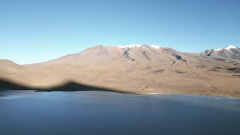 Laguna-Route-and-Volcanic-Peaks-in-Bolivia,-Blue-Water-Lagoon-in-Natural-Reserve-Valley,-Idyllic-Surreal-Travel-and-Tourism-Destination,-Latin-America,-Aerial-View