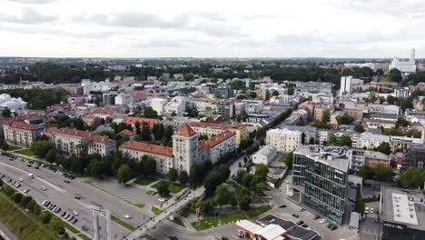 Modern-and-old-building-mixing-in-Kaunas-city-skyline,-aerial-drone-view