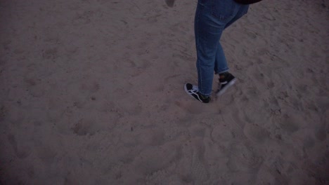slow-motion-tracking-shot-of-a-girl-walking-on-a-sand-beach